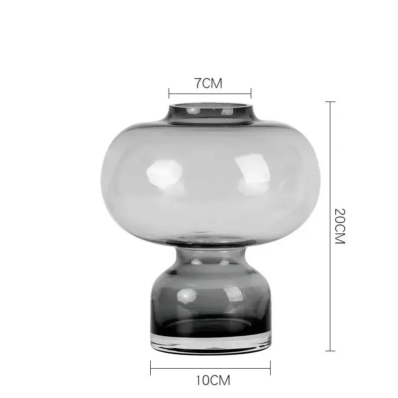 A sleek translucent gray glass green gourd vase with a rounded bulbous body and matching base for living room decor