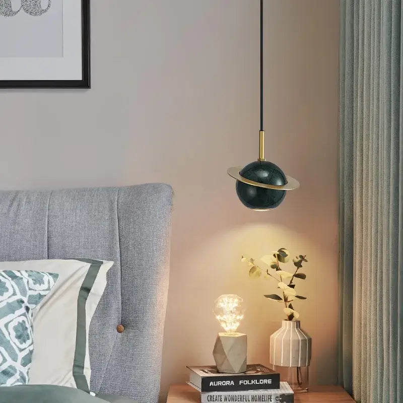 Modern emerald green marble led pendant lamp featuring a dark green planet-shaped pendant light with gold-toned accents