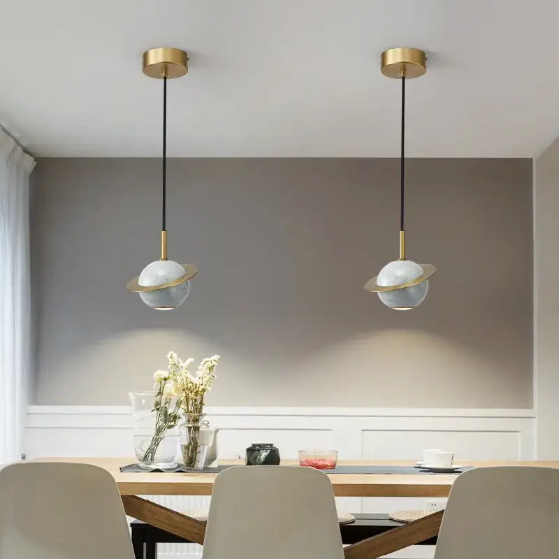 Modern emerald green marble led pendant lamp featuring two gold finished pendant lights with white glass globes