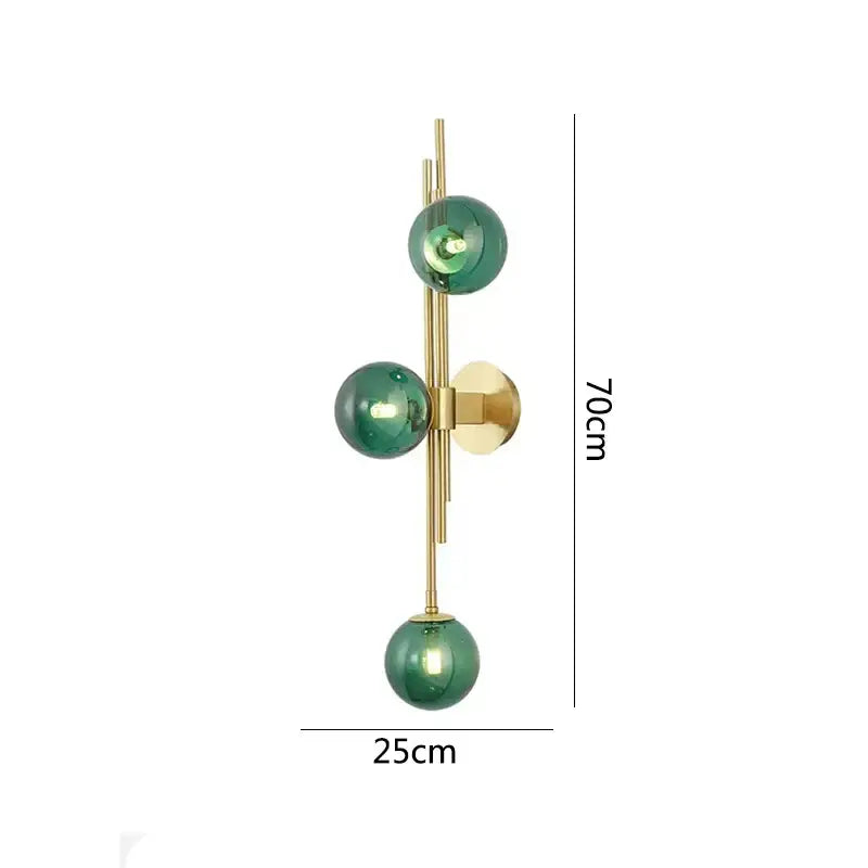 Modern wall lamp featuring three emerald green glass spheres on a gold-toned metal frame for bedroom decorbites green white design