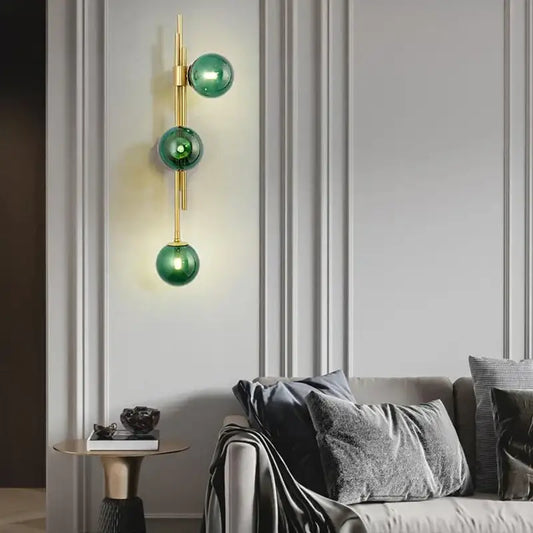 Modern emerald green white glass wall lamp with three stacked spheres and gold-toned metal accents for bedroom decorbites green white