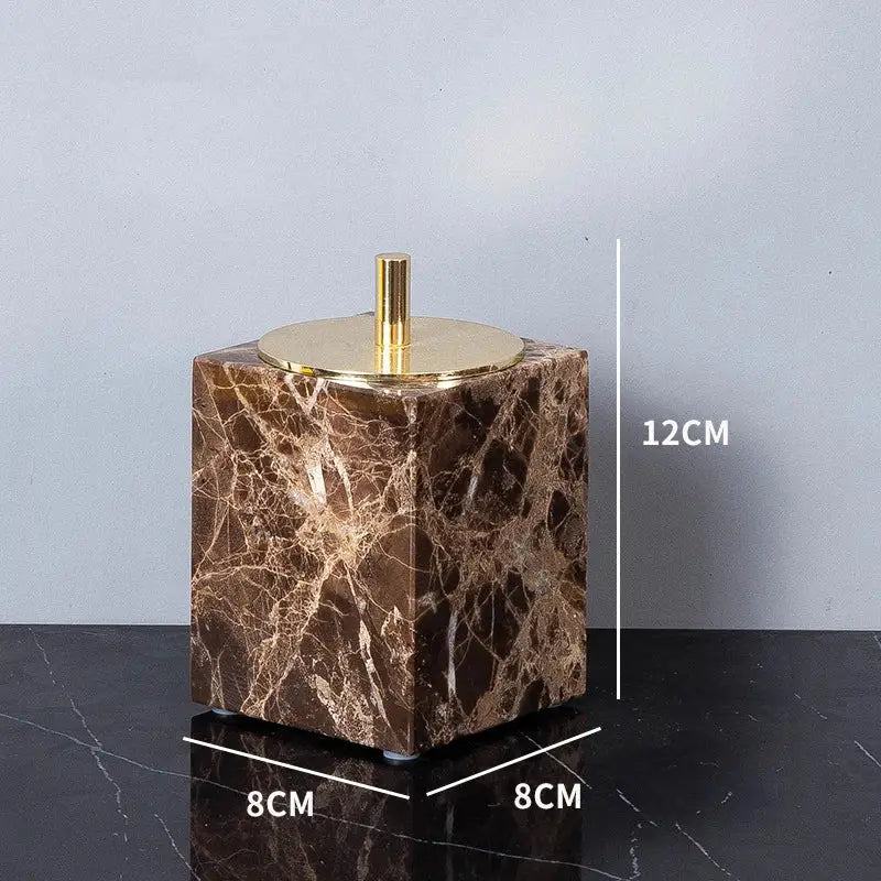 Brown emperador dark marble cube with gold-toned circular lid and central stem from modern emperador dark marble bathroom set