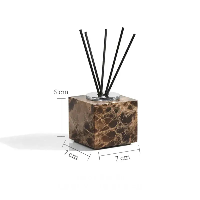 Brown emperador dark marble cube diffuser with six black reed sticks from modern bathroom set with chrome accents