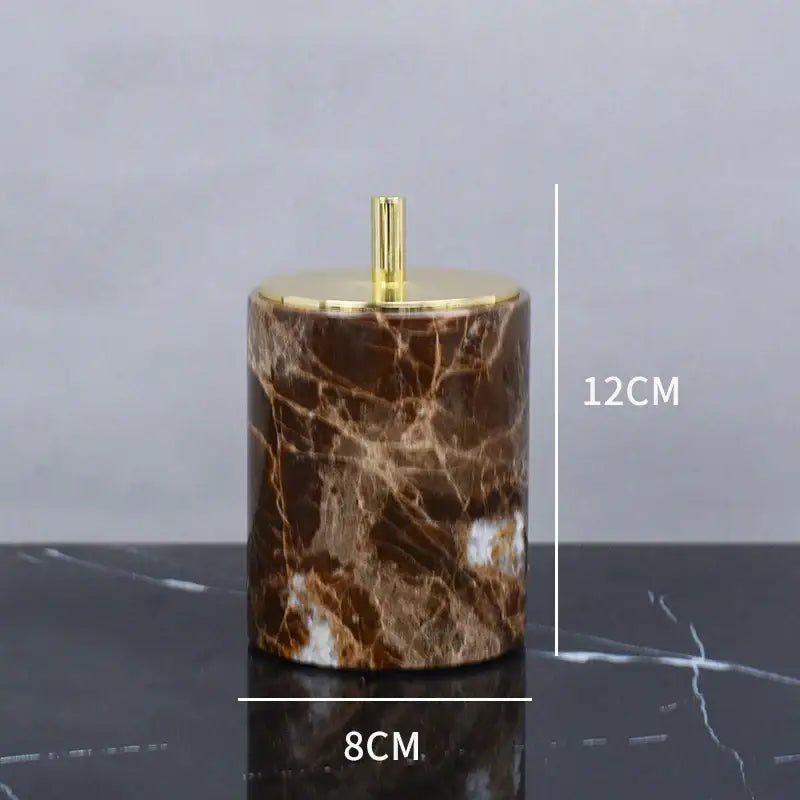 Modern emperador dark marble cylindrical ashtray with gold toned lid and central stem for bathroom use