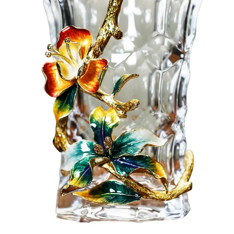 A clear textured crystal glass vase with vibrant orange green yellow enamel flowers for modern living room decor