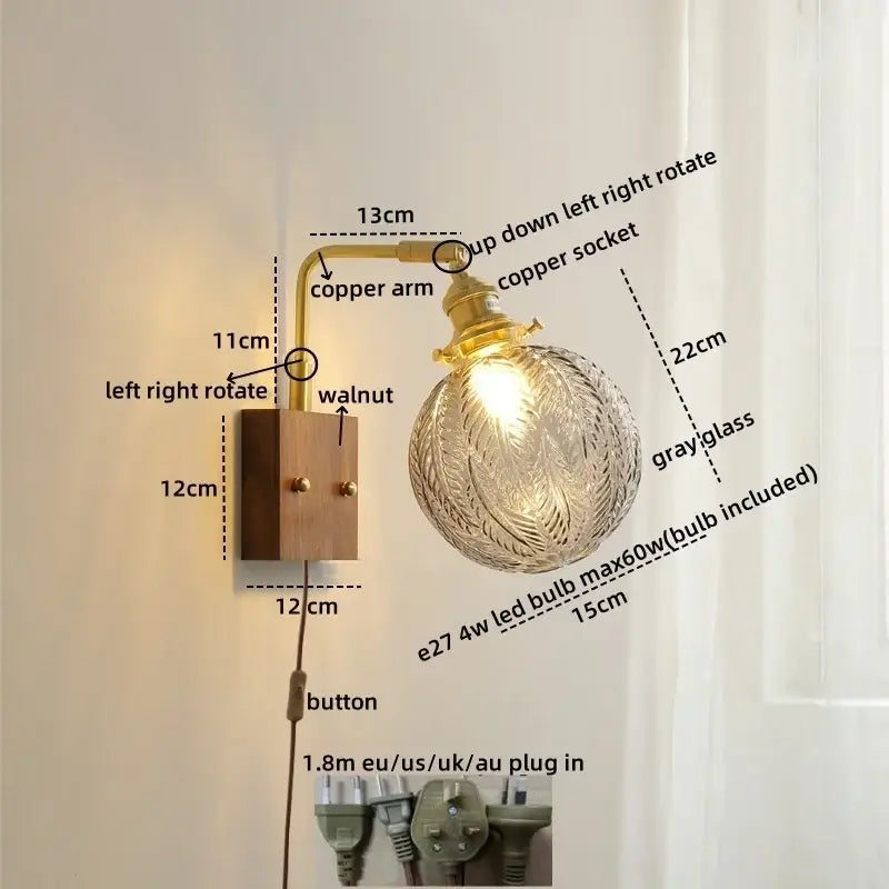 Modern etched glass copper led wall light with copper arm, walnut base, and gray globe with intricate leaf etching