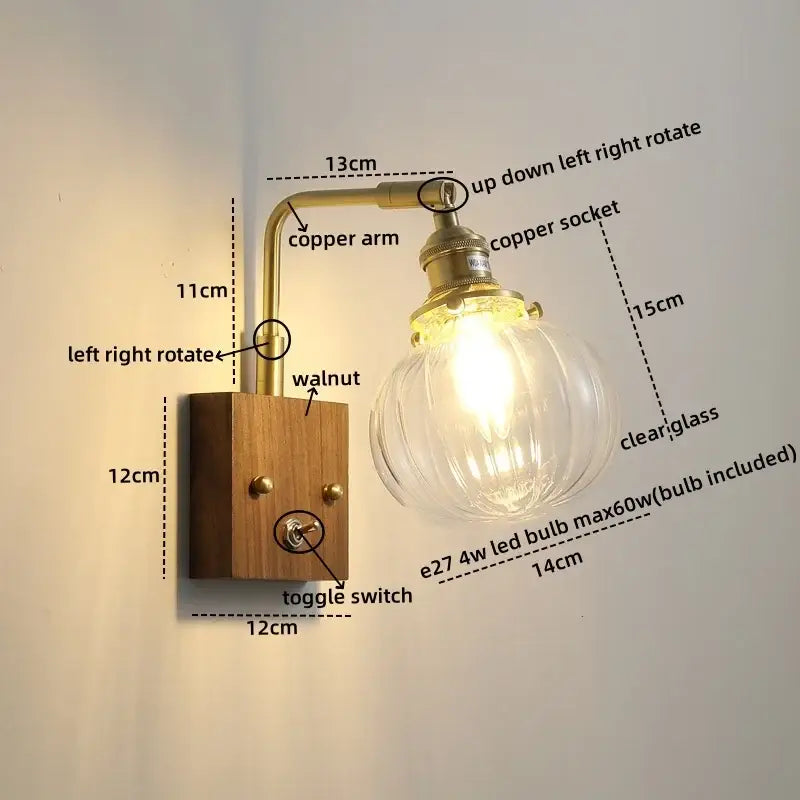Brass-finished copper led wall light with etched glass bulb and walnut wood base for modern bedroom wall lights