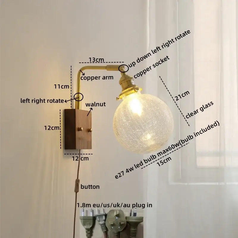 Brass-finished copper led wall light with clear textured glass globe and walnut wood base for modern bedroom sconce lighting