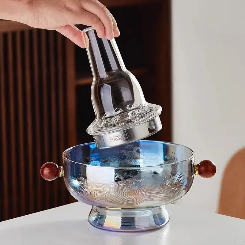 A sleek translucent blue decorbites glass hotpot with intricate wave etchings and polished red wood handles