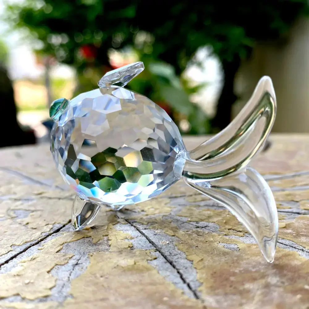 A sparkling faceted crystal goldfish glass miniature sculpture with clear body and green-tinted eye for decorbites decor
