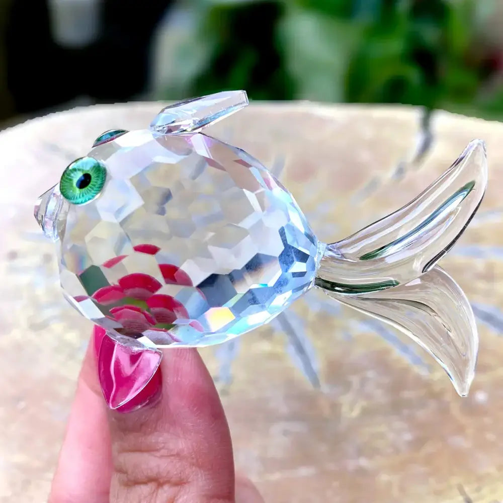 A sparkling clear faceted crystal goldfish glass miniature sculpture with green eye and pink detailing for decorbites