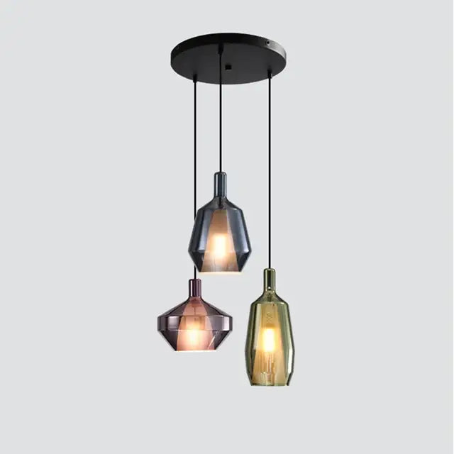 Set of three modern faceted glass pendant lights in black rose gold and amber tones for home art decor