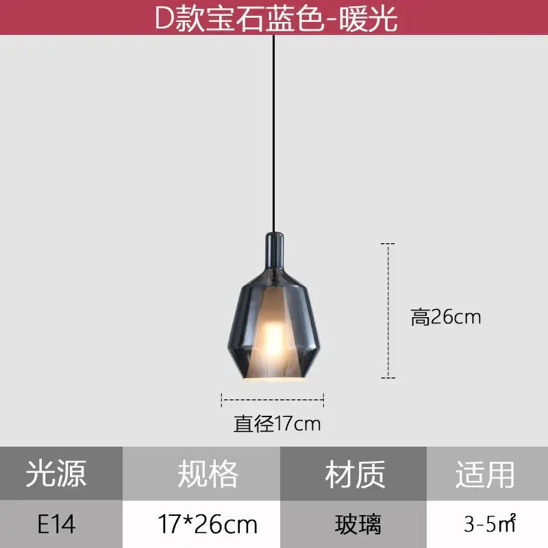 A sleek dark faceted glass pendant light with a warm glow for modern dining room pendant lights and home art decor
