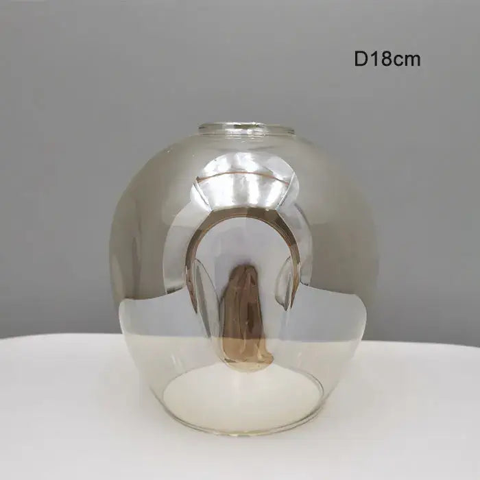 Modern faceted glass shade replacement with reflective metallic finish and smooth contours for living room lamps