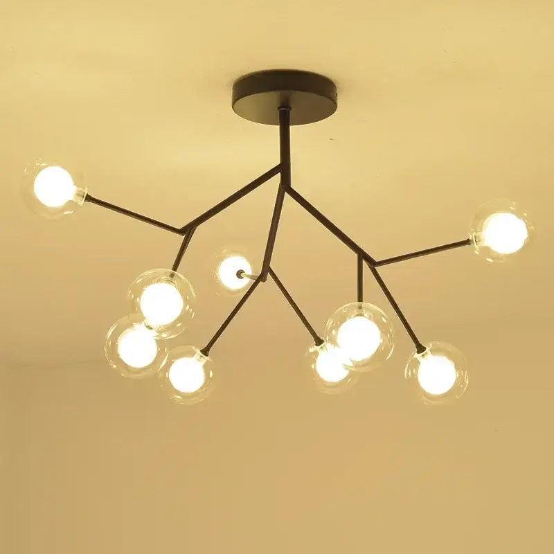 Modern black metal firefly glass round chandelier with clear globe bulbs in a branching design for dining room decorbites heracleum firefly