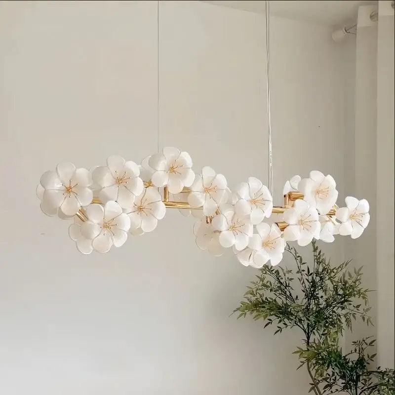 Elegant white ceramic flower pendant light with gold-toned metal finish for practical illumination in kitchens