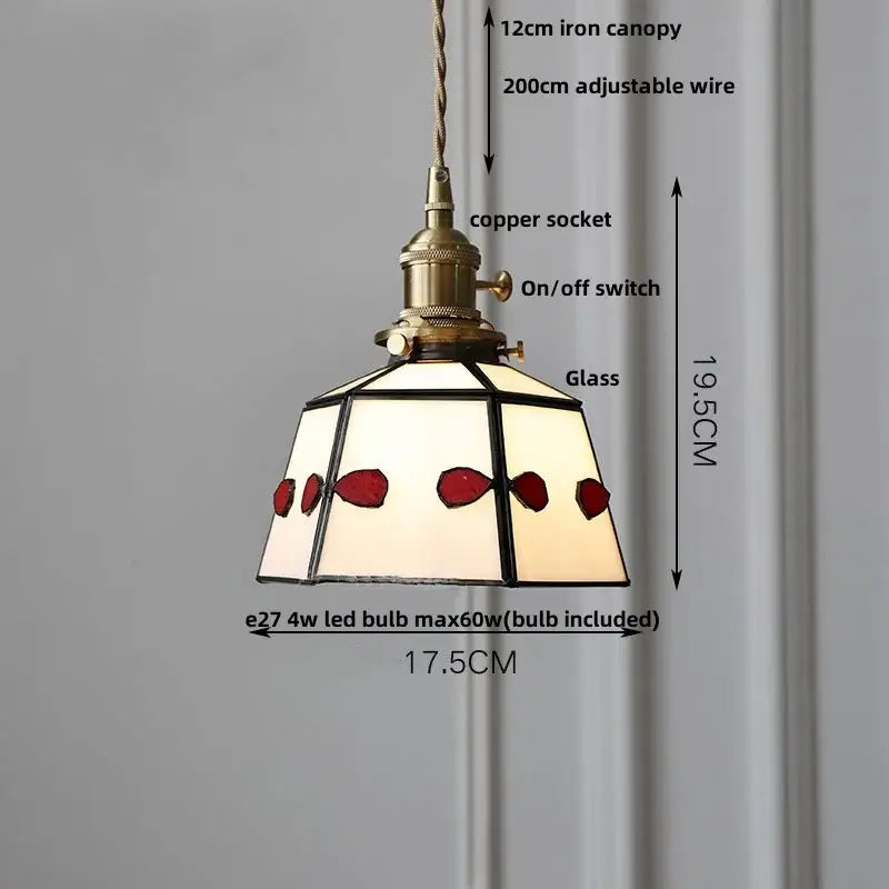 Antique-style pendant light with brass copper socket and black-framed stained glass shade featuring red and cream panels