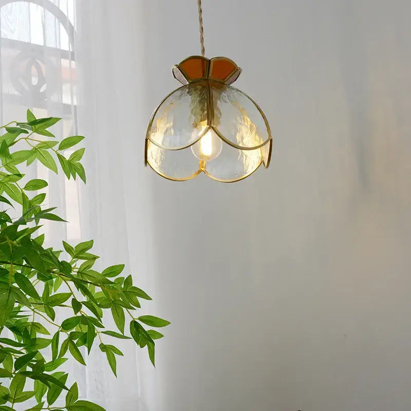 A gold-toned modern flower clear glass led pendant light with translucent textured shade for dining room decorbites