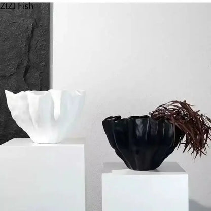 Modern fluted black resin bud vase with glossy petal-like ridges and dark brown dried foliage for bedroom decorbites black resin decor