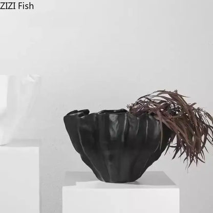 Modern fluted black resin bud vase with textured ruffled design and glossy finish for floral decorbites black resin decor