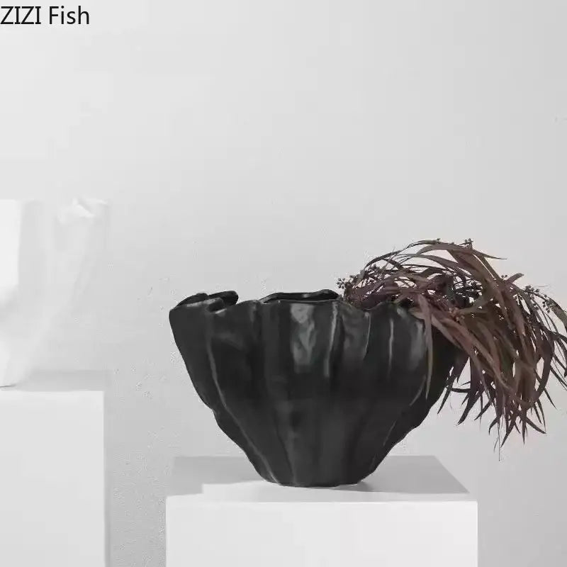 Modern fluted black resin bud vase with textured ruffled design and glossy finish for floral decorbites black resin decor