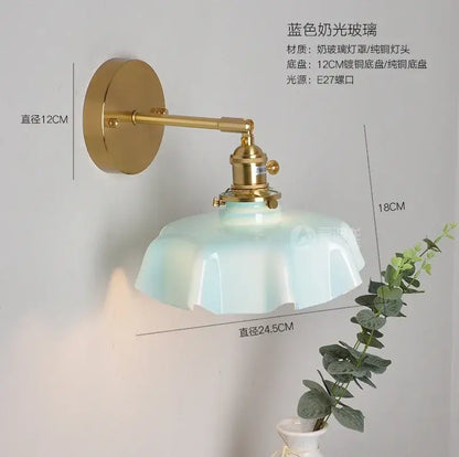 Modern blue frosted glass pendant light with fluted petal design on polished brass arm for dining room lighting
