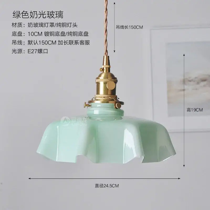 A mint green frosted glass pendant light with brass fixture and 150cm twisted cord for modern dining rooms