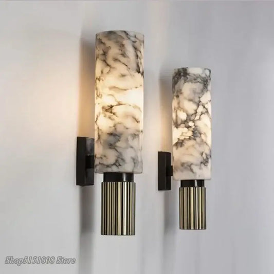 Pair of elegant marble-patterned wall light sconces with fluted metallic bases in decorbites dolomite marble design