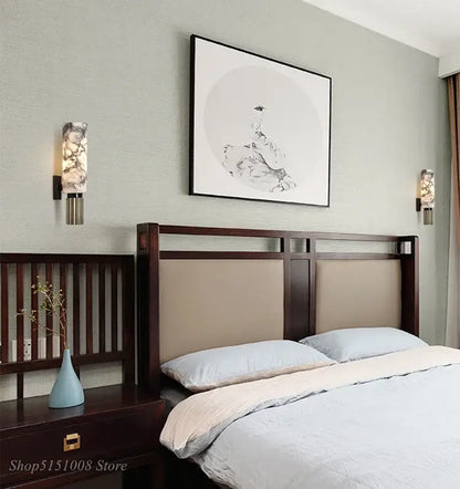 Dark wood headboard with beige upholstered panels and geometric frame paired with decorbites dolomite marble wall light