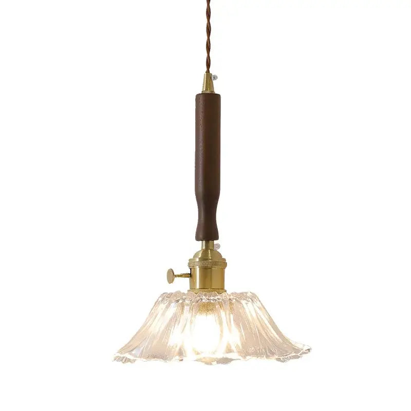 A vintage-style pendant light with dark brown wood handle brass hardware and clear fluted glass shade for led walnut copper decorbites