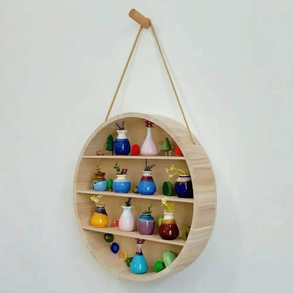 Modern four tier circular wooden frame light wood hanging shelf displaying colorful ceramic vases and decor items