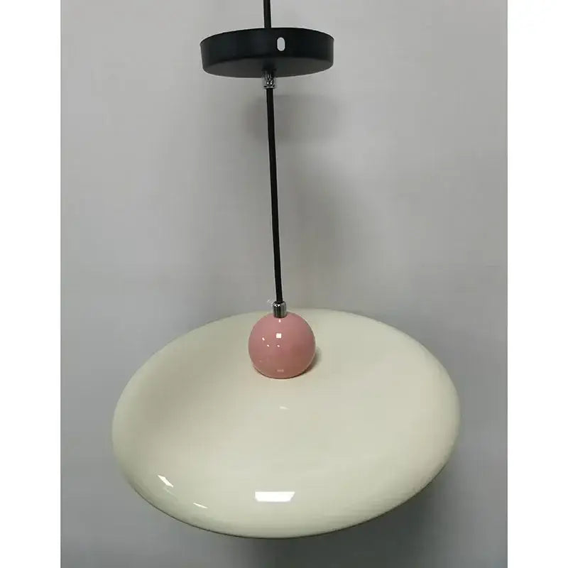 Modern french cream metal pendant light with cream ceramic shade and glossy pink spherical accent for dining room