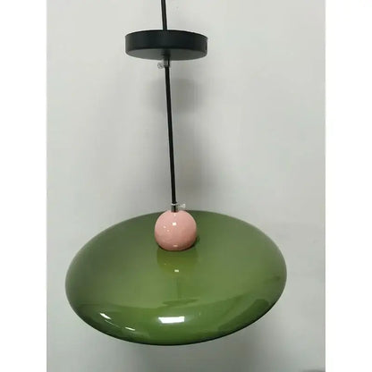 Modern french cream metal pendant light featuring an olive green glossy disc and a pink spherical accent for dining room
