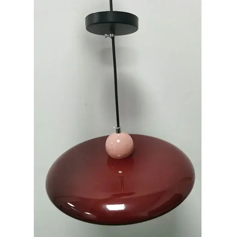 Modern french cream metal pendant light with a sleek glossy burgundy disc shade and pink accent for dining room
