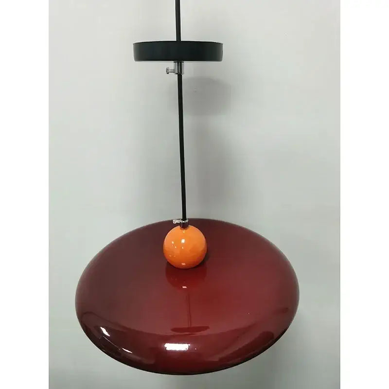 Modern french cream metal pendant light featuring a sleek burgundy finish and orange accent for dining room spaces