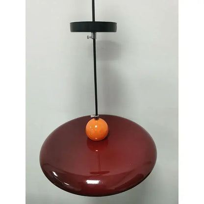 Modern french cream metal pendant light featuring a sleek burgundy finish and orange accent for dining room spaces