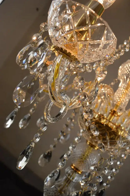A modern french gold crystal floor lamp with intricate cut glass and gold-toned metal for elegant living room decor