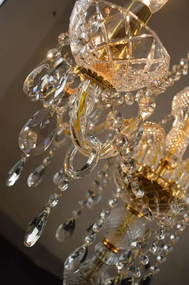 A modern french gold crystal floor lamp with intricate cut glass and gold-toned metal for elegant living room decor