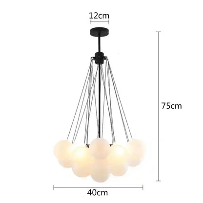 Modern black metal pendant lights with multiple frosted glass ball shades suspended by thin cords for dining room use
