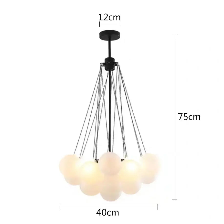 Modern black metal pendant lights with multiple frosted glass ball shades suspended by thin cords for dining room use