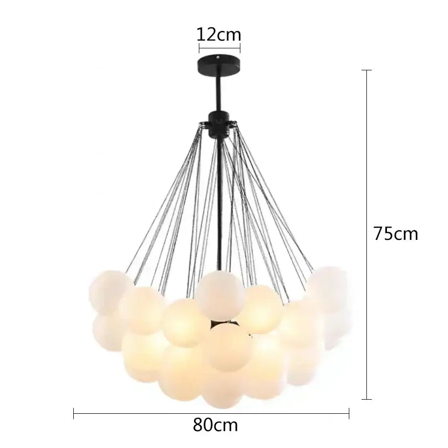 Modern black metal pendant lights with frosted glass ball spheres suspended by thin wires for dining room use