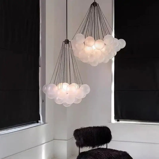 Modern frosted glass ball cloud pendant lights with translucent frosted glass spheres and dark metal chains for dining room