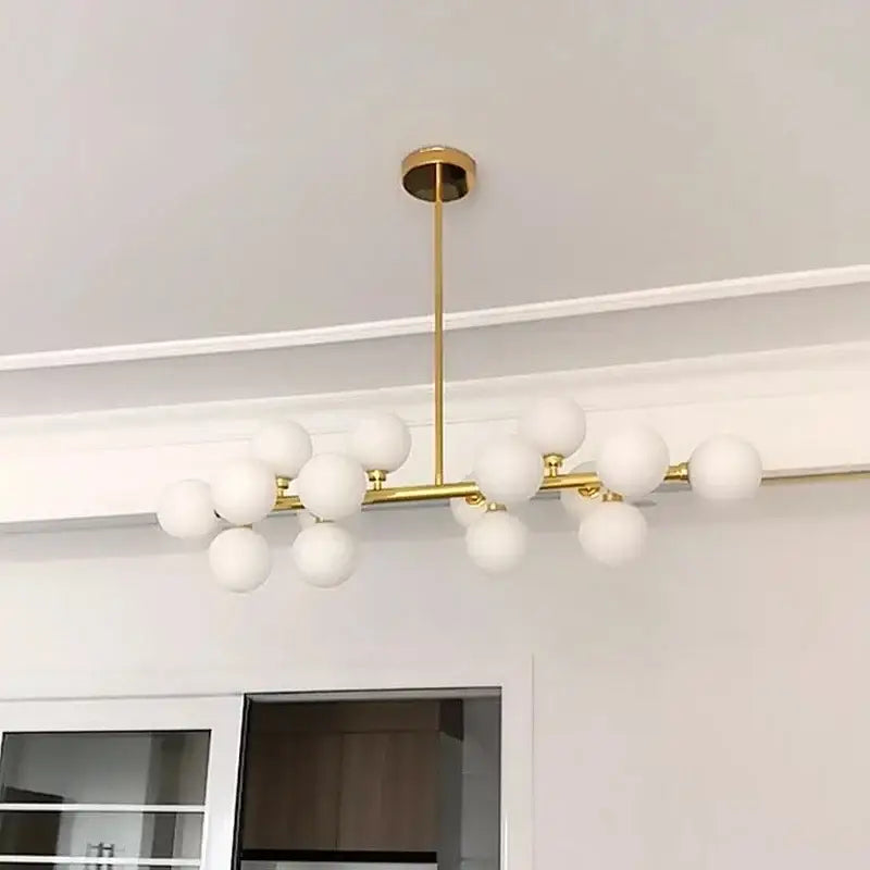 Gold-toned modern frosted glass ball led chandelier with multiple globe bulbs in a branching design for dining room decorbites glass ball