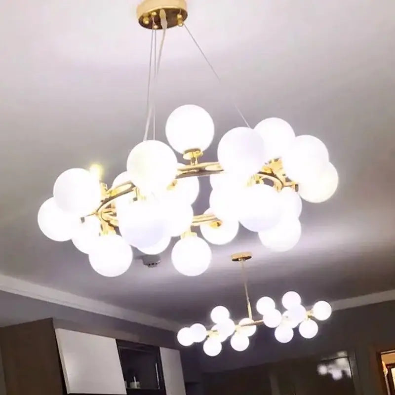 Modern frosted glass ball led chandelier with gold-toned branches and white spherical globes for dining room decorbites glass ball