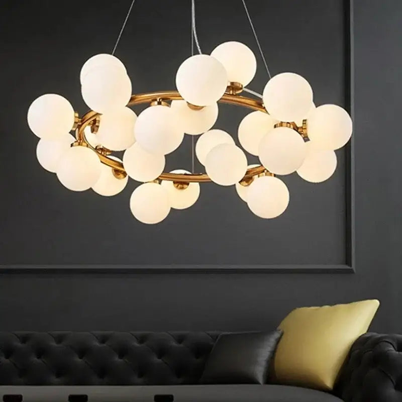 Gold-toned modern frosted glass ball led chandelier with multiple globe bulbs in a circular cluster for dining room decorbites glass ball