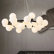 Modern frosted glass ball led chandelier with multiple white spherical glass globes on dark metal frame for dining room decorbites glass ball