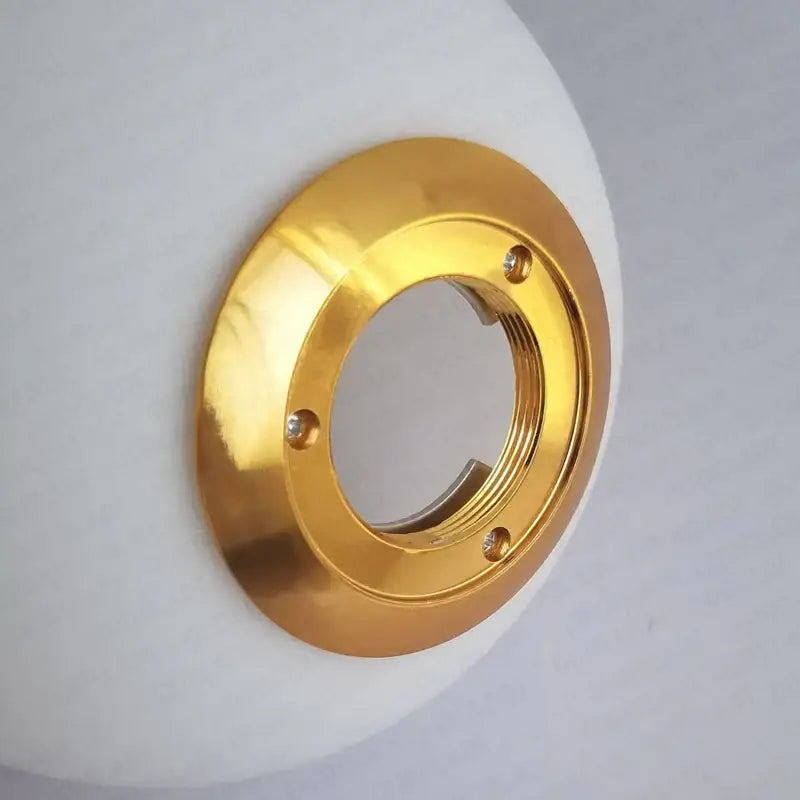 Modern frosted glass ball pendant light with gold ring features a gold metallic faucet escutcheon with three screws
