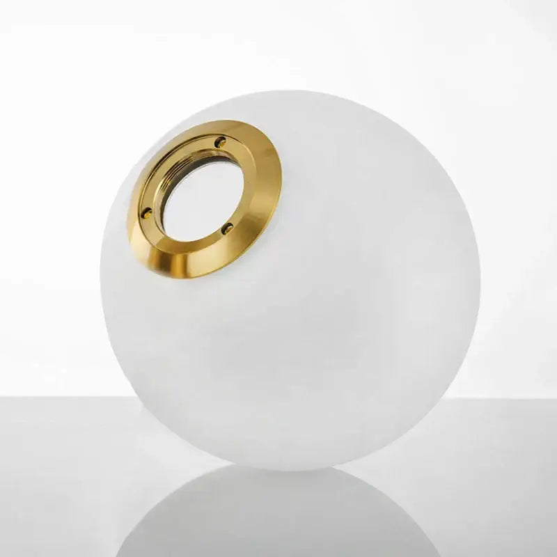 Modern frosted glass ball pendant light with a gold-toned metal ring from decorbites glass ball collection for bedroom decor