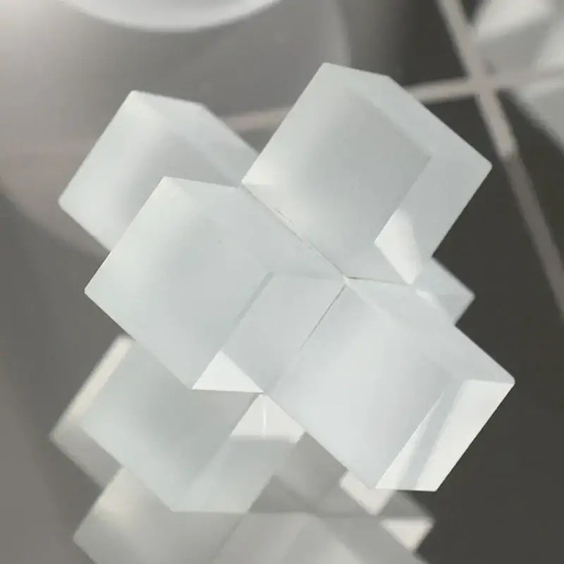 A translucent white decorbites frosted glass geometric tic tac toe set with interlocking cubic elements for living room decor