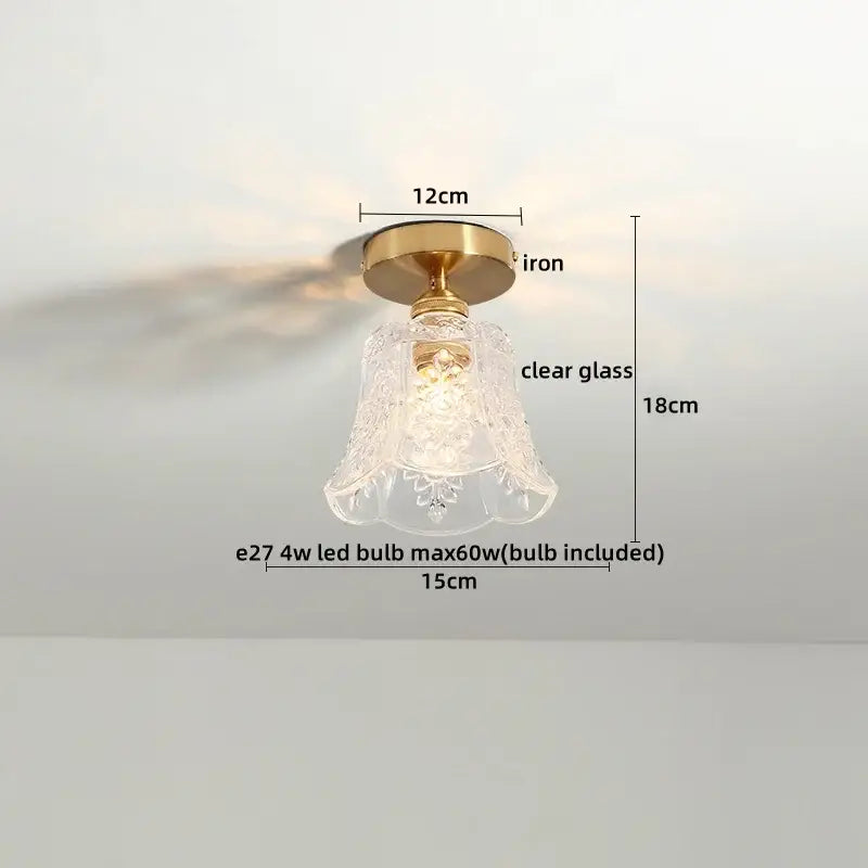 A vintage-style ceiling light with brass iron base and etched clear glass shade for modern frosted glass led ceiling use